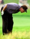 FILE - In this June 16, 2002, file photo, Phil Mickelson looks at his ball in the rough on the 16th hole during the final round of the U.S. Open Golf Championship at the Black Course of Bethpage State Park in Farmingdale, N.Y. Mickelson, five shots behind at the start of the final round, birdied the par-5 13th to get within two shots of the lead, but his tee shot on the 16th found the rough and he couldn't reach the green, making bogey. (AP Photo/Mark Lennihan, File)