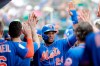 FILE - In this March 16, 2019, file photo, New York Mets' Robinson Cano (24) celebrates in the dugout with his teammates after scoring in the third during an exhibition spring training baseball game against the Miami Marlins in Jupiter, Fla. (AP Photo/Brynn Anderson, File)