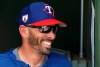 FILE - In this March 6, 2019, file photo, Texas Rangers manager Chris Woodward smiles as he talks with other coaches prior to a spring training baseball game against the San Francisco Giants in Surprise, Ariz. (AP Photo/Ross D. Franklin, File)