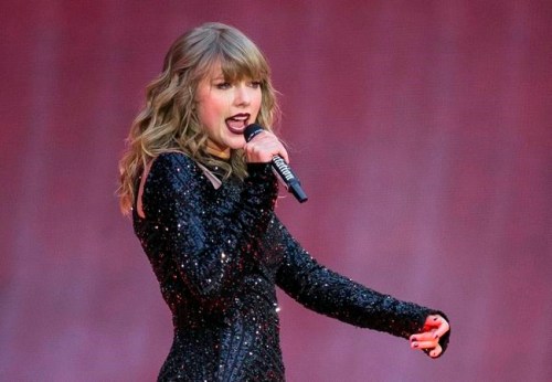 FILE - In this June 22, 2018, file photo, singer Taylor Swift performs on stage in concert at Wembley Stadium in London. A 27-year-old Austin, Texas, man has pleaded guilty to stalking and sending threatening letters and emails to pop star Taylor Swift's former record label. Federal prosecutors in Nashville, Tennessee, said in a news release the letters to Big Machine Label Group began in January 2018 with Eric Swarbrick asking the CEO to introduce him to Swift. (Photo by Joel C Ryan/Invision/AP, File)