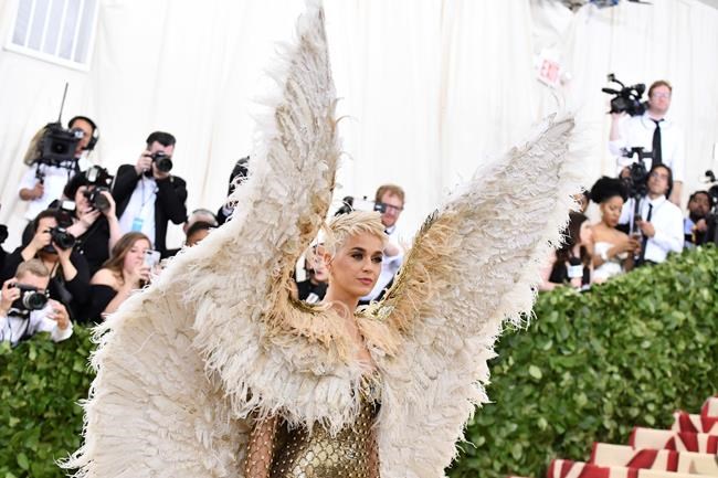 FILE - In this May 7, 2018 file photo, singer Katy Perry wears angel wings at The Metropolitan Museum of Art's Costume Institute benefit gala celebrating the opening of the Heavenly Bodies: Fashion and the Catholic Imagination exhibition in New York. (Photo by Charles Sykes/Invision/AP, file)