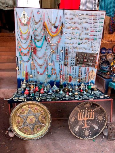 This Jan. 16, 2019, photo shows platters adorned with a menorah and Jewish stars in an outdoor stall near Ksar of Ait-Ben-Haddou in southern Morocco. The North African kingdom once had a thriving Jewish population. Jews of Moroccan descent return often on heritage tours. (Leanne Italie via AP)