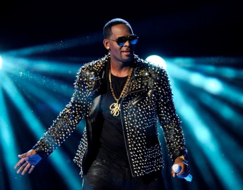 FILE - In this June 30, 2013 file photo, R. Kelly performs at the BET Awards in Los Angeles. Kelly has asked the Chicago judge to let him travel overseas for concerts in Dubai, saying he‚Äôs been unable to get work anywhere in the U.S. since his arrest on charges he sexually abused three minor girls and an adult woman. The request in a Wednesday filing says the R&B star will perform at up to five concerts in the oil-rich nation in the Middle East. A judge ordered Kelly to surrender his passport after his arrest last month on 10 counts of aggravated sexual abuse. (Photo by Frank Micelotta/Invision/AP, File)