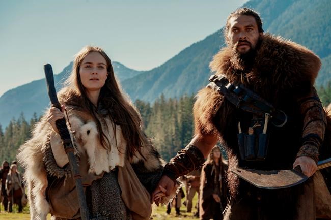 This image released by Apple TV Plus shows Jason Momoa, right, and Hera Hilmar in a scene from
