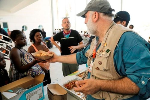 This Sept. 6, 2019 photo released by Amilcar Navarro shows chef Jose Andres distributing food at the Marsh Harbour Government Complex in Abaco, Bahamas, in the wake of Hurricane Dorian. Andres, who has two James Beard Awards and nearly three dozen restaurants, founded the nonprofit World Central Kitchen in 2010 to respond quickly with food and water distribution after natural disasters and other emergencies around the globe. (Amilcar Navarro via AP)