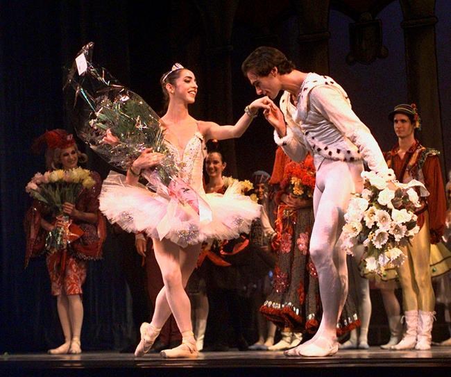 FILE - This Jan. 27, 1998 file photo shows Oscar Torrado kissing ballerina Lorna Feijoo on the hand during a curtain call following Ballet Nacional de Cuba's performance of