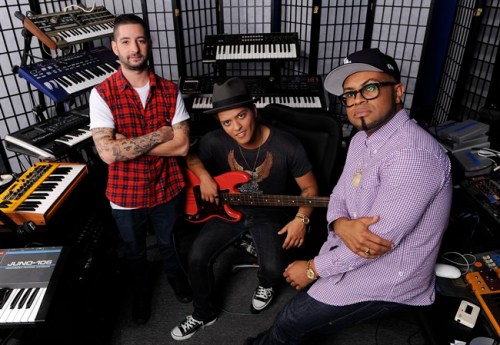 In this Jan. 4, 2012 photo, Ari Levine, left, Bruno Mars, center, and Philip Lawrence of the songwriting and production team The Smeezingtons, pose for a portrait at their recording studio in the Hollywood section of Los Angeles. (AP Photo/Chris Pizzello)