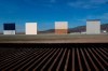 FILE - In this Wednesday, Dec. 12, 2018, file photo, border wall prototypes stand in San Diego near the Mexico-U.S. border, seen from Tijuana, Mexico, where the current wall casts a shadow in the foreground. (AP Photo/Moises Castillo, File)