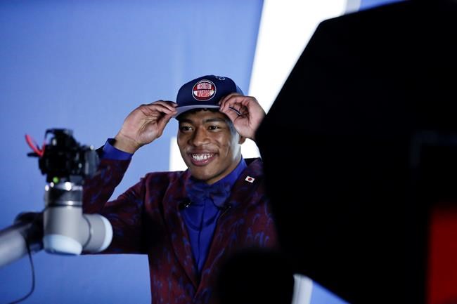 Japan's Rui Hachimura, of Gonzaga, poses for photographs after the Washington Wizards selected him as the ninth pick overall pick in the NBA basketball draft Thursday, June 20, 2019, in New York. (AP Photo/Julio Cortez)