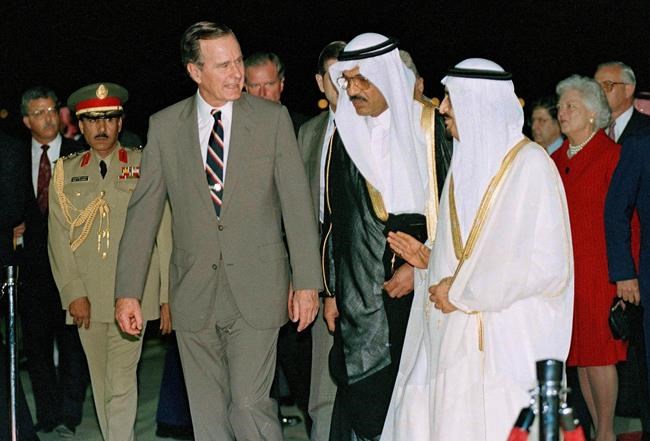 FILE - In this Nov. 21, 1990 file photo, President George H.W. Bush is greeted by King Fahd as he arrives in Saudi Arabia. At right is first lady Barbara Bush. At center is an interpreter. Bush died at the age of 94 on Friday, Nov. 30, 2018, about eight months after the death of his wife, Barbara Bush. (AP Photo/J. Scott Applewhite, File)