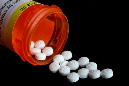 FILE - This Aug. 29, 2018, file photo shows an arrangement of prescription oxycodone pills in New York. U.S. health officials Tuesday, April 9. 2019, warned doctors not to abruptly stop prescribing opioid painkillers to patients who are taking them for chronic pain ailments, such as backaches. (AP Photo/Mark Lennihan, File)