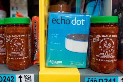 FILE - This Dec. 20, 2017, file photo shows the Amazon Echo Dot stocked on a shelf alongside jars of Garlic Chili Sauce at the Amazon Prime warehouse in New York. Consumer advocates say the kids‚Äô version of Amazon‚Äôs Alexa won‚Äôt forget what children tell it, even after parents try to delete the conversations. A coalition of groups on Thursday, May 9, 2019, is planning to ask the Federal Trade Commission to investigate whether Amazon is holding onto children‚Äôs voice recordings and personal information longer than it should. (AP Photo/Mark Lennihan, File)