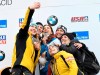 Jacqueline Loelling, of Germany, left, takes a selfie photograph with the top sixth finishers after tying for first place with Elena Nikitina, of Russia, third from left, in the women's skeleton World Cup competition in Lake Placid, N.Y., Friday, Feb. 15, 2019. (AP Photo/Hans Pennink)