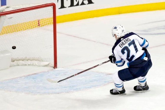 Winnipeg Jets left wing Nikolaj Ehlers (27), of Denmark, scores on an empty New York Islanders net during the third period of an NHL hockey game, Tuesday, Dec. 4, 2018, in New York. The Jets won 3-1. (AP Photo/Julio Cortez)