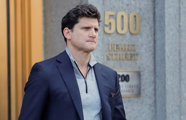 Gordon Caplan of Greenwich, Conn., walks out of federal court Tuesday, March 12, 2019, in New York. Fifty people, including Hollywood stars Felicity Huffman and Lori Loughlin, were charged Tuesday in a scheme in which wealthy parents allegedly bribed college coaches and other insiders to get their children into some of the nation's most selective schools. Caplan, who is co-chairman of the international law firm Willkie Farr & Gallagher, was accused of paying $75,000 to get a test supervisor to correct the answers on his daughter's ACT exam after she took it. (AP Photo/Julie Jacobson)