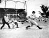 FILE- In this March 22, 1937, file photo Lou Gehrig bats the ball for the New York Yankees in his first exhibition game of the season against the Boston Bees in St. Petersburg, Fla. Al Lopez is the Bees' catcher and Tiny Parker is the home plate umpire. A collection of Gehrig memorabilia, which includes various photographs, letters and signed documents, and baseballs, is now available as part of Heritage Auctions' latest offering. (AP Photo, File)