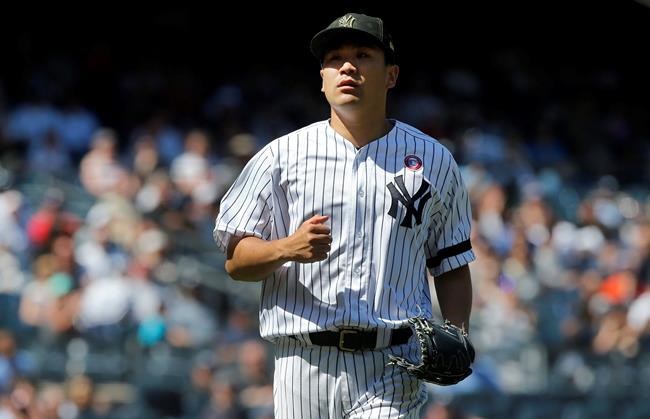 New York Yankees starting pitcher Masahiro Tanaka walks to the dugout after the sixth inning of a baseball game against the Tampa Bay Rays , Saturday, May 18, 2019, in New York. (AP Photo/Jim McIsaac)