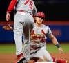St. Louis Cardinals' third base coach Ron Warner congratulates Harrison Bader (48) after he stole third base during the third inning of a baseball game against the New York Mets, Thursday, June 13, 2019, in New York. (AP Photo/Kathy Willens)