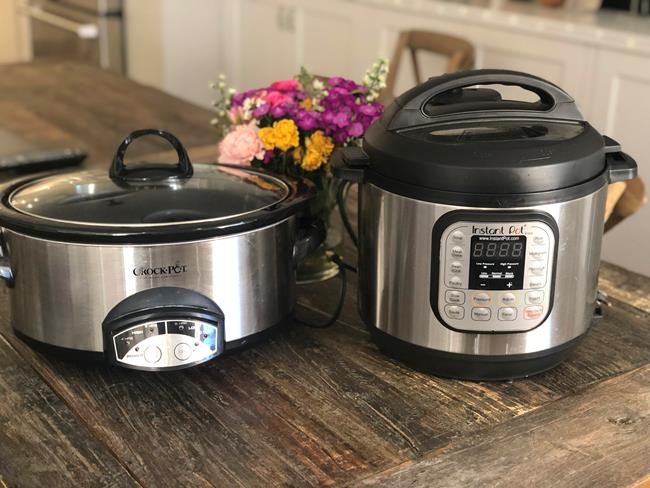 This March 18, 2019 photo shows two well loved small appliances, a slow cooker, left, and an Instant Pot, in a New York home. Which appliance you prefer will depend on what you plan to use them for. (Katie Workman via AP)