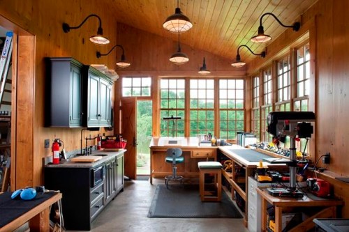This photo provided by Rill Architects shows the inside of a garage in Emmitsburg, Md. Detached garages with a second floor, as seen in this project designed by the Bethesda, Md. based firm Rill Architects, can serve as a space to store cars while also pulling double-duty as guest suites, rooms for crafting or even a playroom for children. If a garage is large enough, it can house a full workshop, shown here, or a home gym, something that's become increasingly popular with homeowners. (James Ray Spahn/Rill Architects via AP)