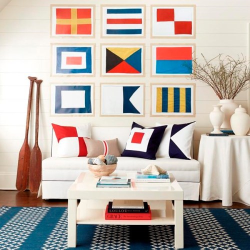 This photo provided by Ballard Designs shows Suzanne Kasler's Seafarer nautical flag collection. The collection places the graphic, modern flags inside natural wood frames; they'd make a striking display either solo or in multiples. (Ballard Designs via AP)