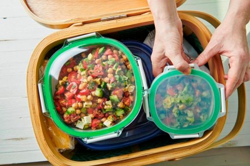 This May 2019 photo shows containers being packed in a picnic basket in New York. Whether it's a simple al fresco lunch or a romantic repast for two, a successful picnic takes planning. Make a checklist and gather ideas for which foods work best. (Cheyenne Cohen/Katie Workman via AP)