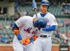 New York Mets' Robinson Cano, left, reacts after being hit by a pitch during the first inning of the MLB baseball game against the Milwaukee Brewers at Citi Field, Sunday, April 28, 2019, in New York. (AP Photo/Seth Wenig)
