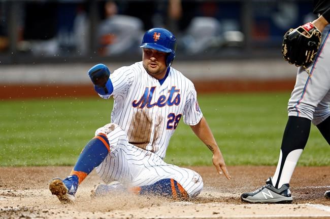 New York Mets' J.D. Davis scores on a wild pitch by Miami Marlins pitcher Pablo Lopez during the first inning of a baseball game Friday, May 10, 2019, in New York. (AP Photo/Adam Hunger)