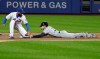 Milwaukee Brewers' Christian Yelich, right, beats the tag by New York Mets shortstop Amed Rosario to steal second base during the first inning of a baseball game Friday, April 26, 2019, in New York. (AP Photo/Frank Franklin II)