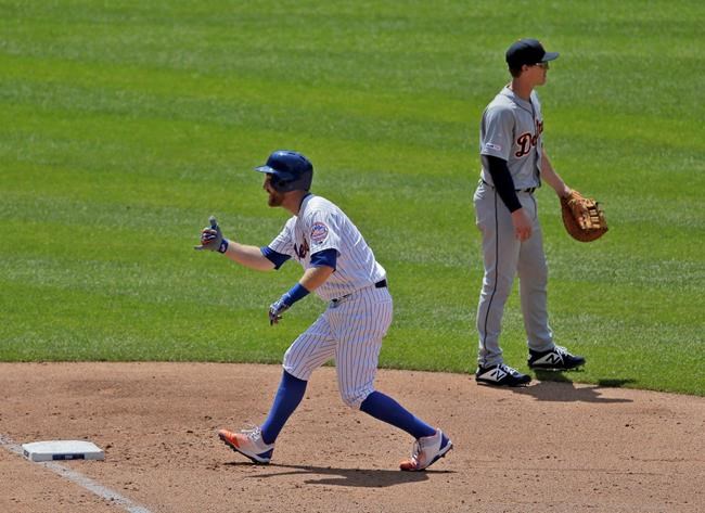 New York Mets' Todd Frazier, left, reacts after hitting an RBI-bunt single during the fourth inning of a baseball game against the Detroit Tigers at Citi Field, Sunday, May 26, 2019, in New York. (AP Photo/Seth Wenig)