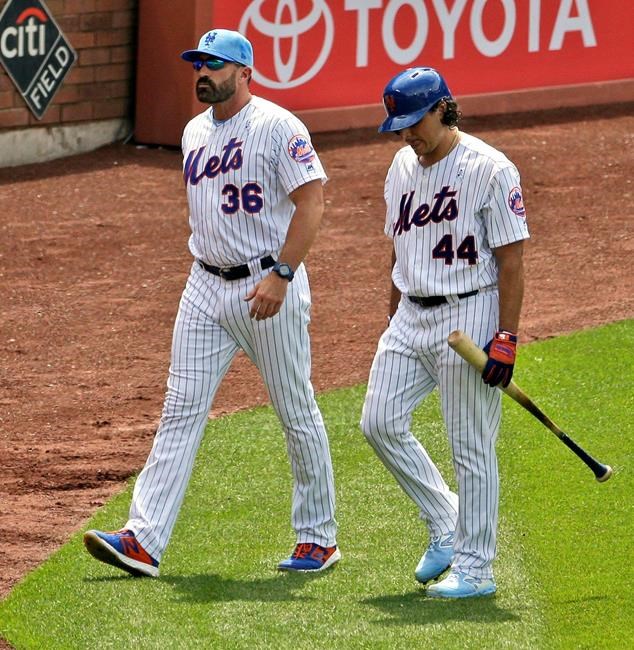 New York Mets' Jason Vargas, right, is accompanied by manager Mickey Callaway as he leaves a baseball game during the fourth inning against the St. Louis Cardinals at Citi Field, Sunday, June 16, 2019, in New York. (AP Photo/Seth Wenig)
