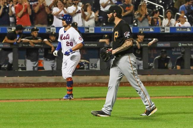 Pittsburgh Pirates starting pitcher Trevor Williams, right, reacts as New York Mets' J.D. Davis heads to home plate to score on a two-run home run during the seventh inning of a baseball game Saturday, July 27, 2019, in New York. (AP Photo/Frank Franklin II)