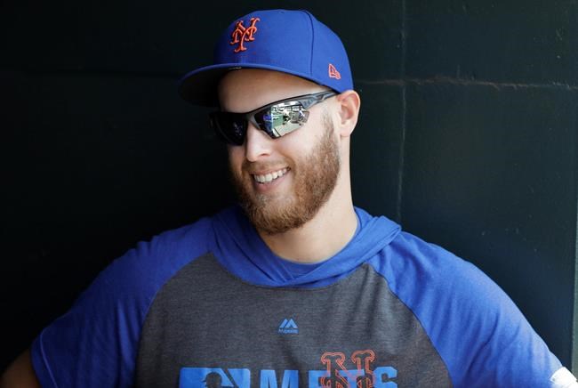 New York Mets' pitcher Zack Wheeler talks to teammates during the fourth inning of a baseball game against the Pittsburgh Pirates Sunday, July 28, 2019, in New York. (AP Photo/Frank Franklin II)