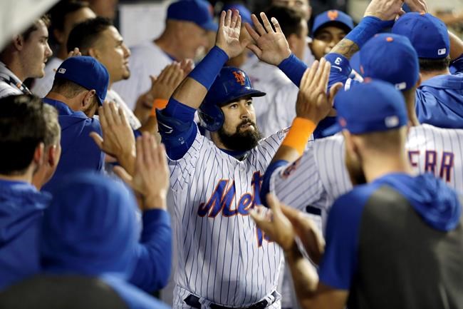New York Mets' Luis Guillorme is greeted by teammates after hitting a home run during the eighth inning of a baseball game against the Washington Nationals, Saturday, Aug. 10, 2019, in New York. (AP Photo/Seth Wenig)