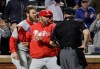 Philadelphia Phillies manager Gabe Kapler, center, restrains Bryce Harper, left, while arguing a call with umpire Mark Carlson during the fourth inning of a baseball game Monday, April 22, 2019, in New York. (AP Photo/Frank Franklin II)