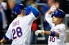 New York Mets' J.D. Davis (28) celebrates with Michael Conforto after scoring on Conforto's home run during the seventh inning of a baseball game against the Miami Marlins on Tuesday, Sept. 24, 2019, in New York. (AP Photo/Kathy Willens)