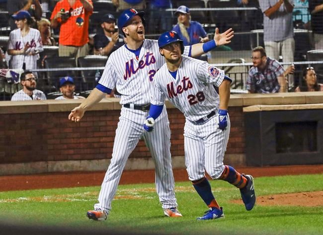 New York Mets' Todd Frazier (21) celebrates with teammate J.D. Davis (28) after they score on a two-run home run by Davis during the seventh inning of a baseball game against the Pittsburgh Pirates Saturday, July 27, 2019, in New York. (AP Photo/Frank Franklin II)