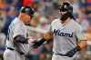 Miami Marlins third base coach Fredi Gonzalez greets Jorge Alfaro (38) as Alfaro rounds the bases after hitting a solo home run during the second inning of a baseball game against the New York Mets, Monday, Sept. 23, 2019, in New York. (AP Photo/Kathy Willens)