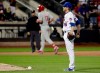 New York Mets relief pitcher Jacob Rhame, right, reacts as Philadelphia Phillies' Rhys Hoskins runs the bases after hitting a two-run home run during the ninth inning of a baseball game, Wednesday, April 24, 2019, in New York. (AP Photo/Frank Franklin II)