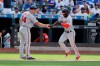 Washington Nationals' Victor Robles, right, celebrates with third base coach Bob Henley as he runs the bases after hitting a two-run home run during the ninth inning of a baseball game Sunday, Aug. 11, 2019, in New York. The Nationals won 7-4. (AP Photo/Frank Franklin II)