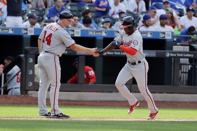 Washington Nationals' Victor Robles, right, celebrates with third base coach Bob Henley as he runs the bases after hitting a two-run home run during the ninth inning of a baseball game Sunday, Aug. 11, 2019, in New York. The Nationals won 7-4. (AP Photo/Frank Franklin II)