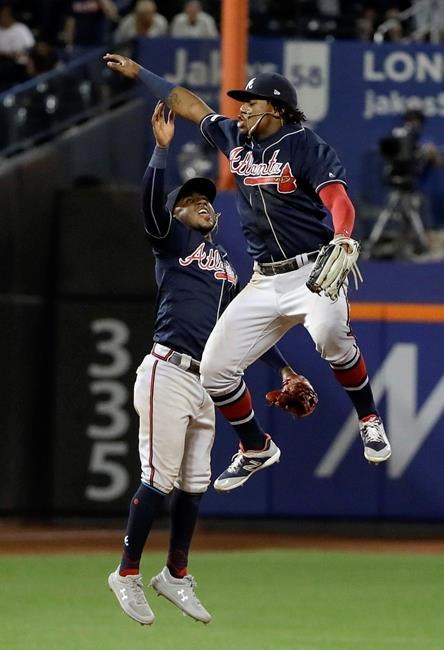 Atlanta Braves' Ozzie Albies, left, celebrates with Ronald Acuna Jr. after a baseball game against the New York Mets, Friday, June 28, 2019, in New York. (AP Photo/Frank Franklin II)
