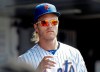 New York Mets pitcher Noah Syndergaard watches his team play during the eighth inning of a baseball game against the Pittsburgh Pirates, Sunday, July 28, 2019, in New York. (AP Photo/Frank Franklin II)