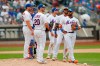 New York Mets' manager Mickey Callaway, left, first baseman Pete Alonso (20), third baseman Jeff McNeil, shortstop Amed Rosario and second baseman Robinson Cano wait out a pitching change during the seventh inning of a baseball game against the Philadelphia Phillies, Sunday, Sept. 8, 2019, in New York. (AP Photo/Kathy Willens)