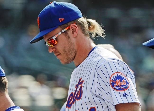 New York Mets starting pitcher Noah Syndergaard leaves the field with teammates after a baseball game against the Pittsburgh Pirates Sunday, July 28, 2019, in New York. The Mets won 8-7. (AP Photo/Frank Franklin II)