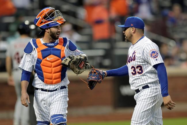 New York Mets catcher Tomas Nido, left, and relief pitcher Hector Santiago talk while heading to the dugout after the top of the 12th inning of a baseball game against the Detroit Tigers, Saturday, May 25, 2019, in New York. (AP Photo/Julio Cortez)