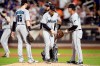 Miami Marlins manager Don Mattingly, right, takes relief pitcher Jeff Brigham, center, out of a baseball game after Brigham gave up three home runs during the seventh inning in the second game of a doubleheader against the New York Mets, Monday, Aug. 5, 2019, in New York. (AP Photo/Mary Altaffer)