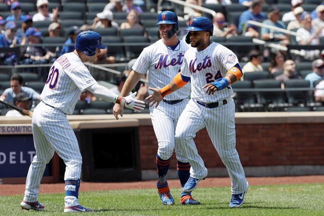 New York Mets' Michael Conforto, left, reaches out to Robinson Cano, right, and Pete Alonso, center, after they scored on a double by Todd Frazier against the San Diego Padres in the first inning of a baseball game, Thursday, July 25, 2019 in New York. (AP Photo/Mark Lennihan)