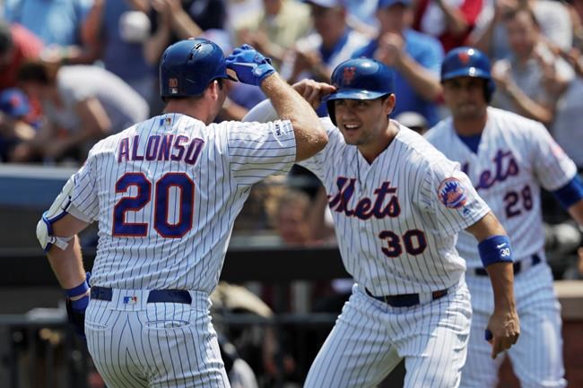 New York Mets' Pete Alonso, left, is met at home plate by teammate Michael Conforto after hitting a two-run home run against the Miami Marlins in the first inning of a baseball game, Wednesday, Aug. 7, 2019, in New York. (AP Photo/Mark Lennihan)