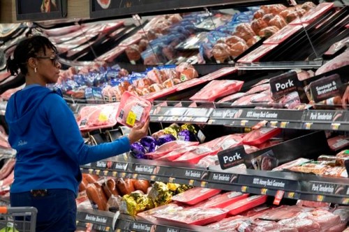 A customer shops at the meat counter at a Walmart Neighborhood Market, Wednesday, April 24, 2019, in Levittown, N.Y. Walmart can rely on thousands of cameras hanging from the ceiling that track when products are running low or when produce or meat start to lose their freshness. (AP Photo/Mark Lennihan)
